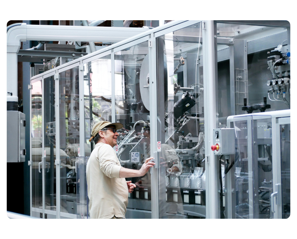 Engineer inspecting polycarbonate and aluminum guarding barrier.