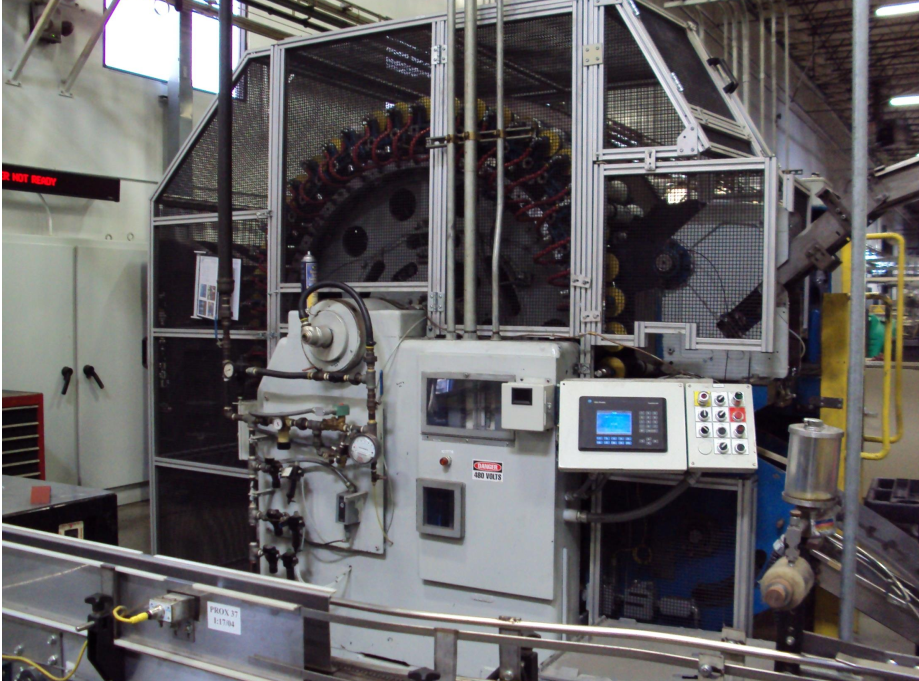 Fully enclosed automated industrial machine with safety guarding and integrated control panel designed to support compliance.